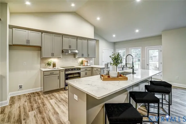 a table with a vase and chandelier