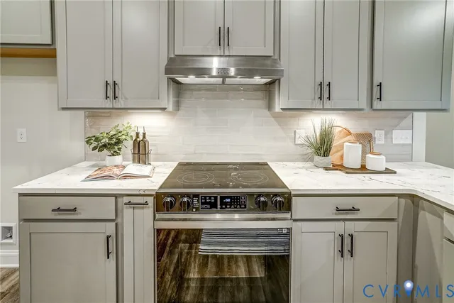 a kitchen with a sink and a stove top oven