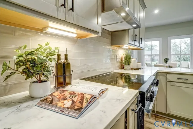 a kitchen with sink stove and refrigerator
