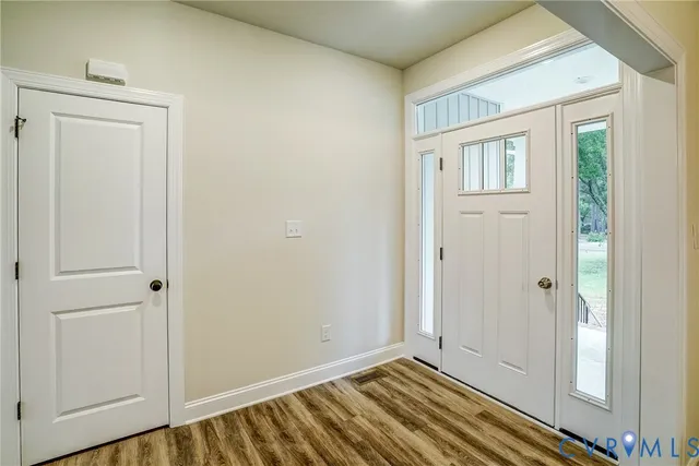 a view of a dining room with furniture wooden floor and a chandelier