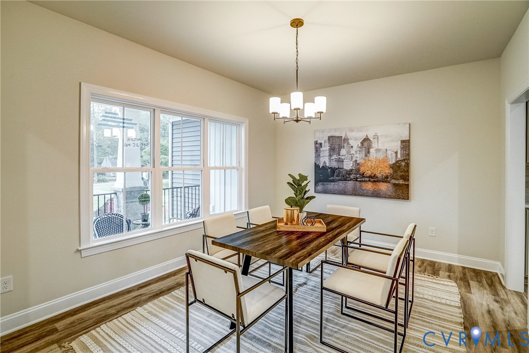2301 Larkwood Road Henrico, VA 23294 - Photo 7 of 23 a view of a dining room with furniture wooden floor and a chandelier