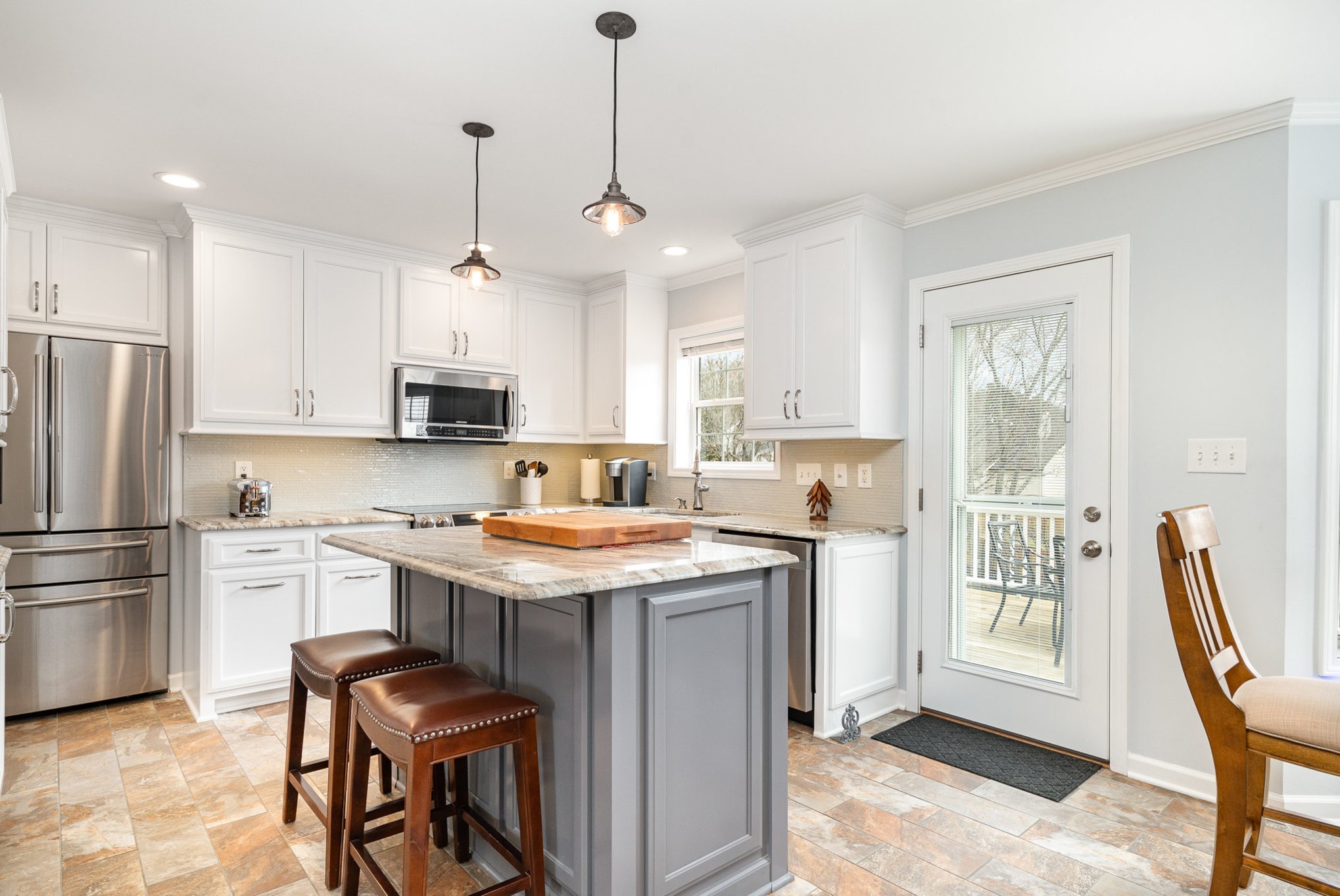 2408 Audelia Way Spring Hill, TN 37174 - Photo 5 of 25 a kitchen with stainless steel appliances granite countertop a stove a refrigerator a oven a sink a stove a dining table and chairs