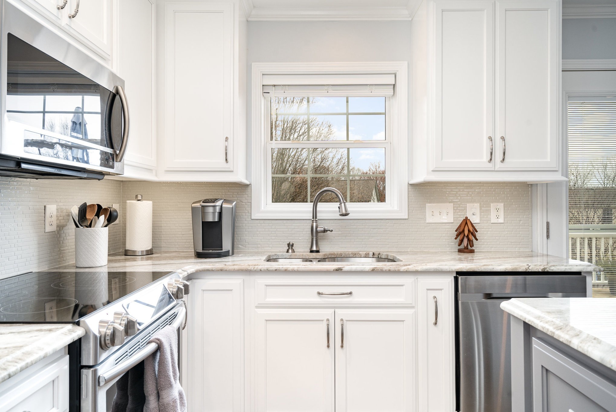 2408 Audelia Way Spring Hill, TN 37174 - Photo 6 of 25 a kitchen with granite countertop a sink a stove and cabinets