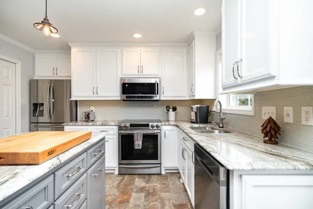 a kitchen with a sink stove and refrigerator