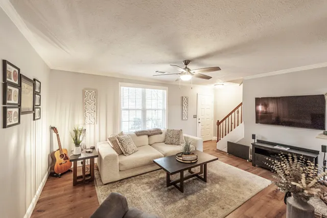 a living room with furniture and a flat screen tv