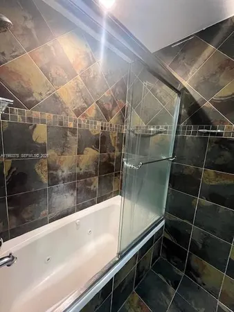 a bathroom with a bathtub and shower