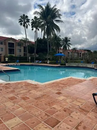 a view of a swimming pool is middle in the garden