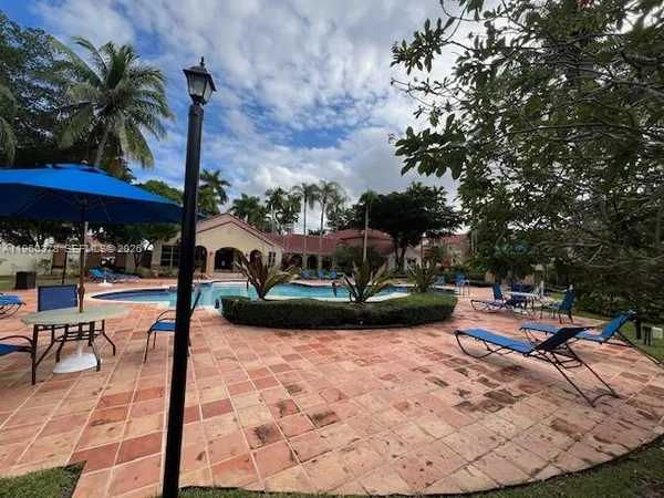 a view of a swimming pool with chairs in patio