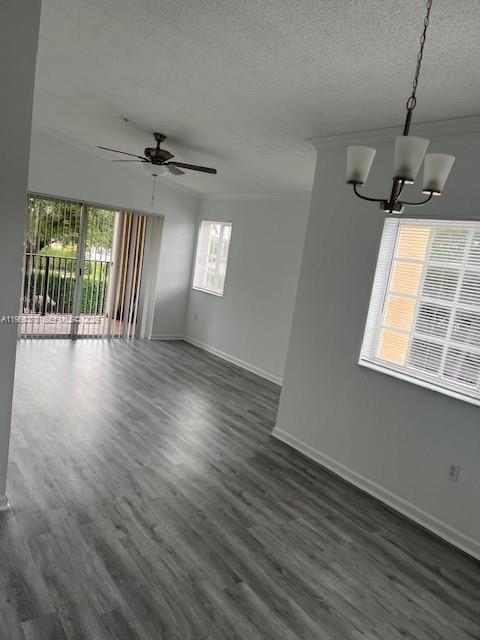 2103 Renaissance Boulevard, Unit 307 Miramar, FL 33025 - Photo 7 of 32 an empty room with wooden floor fan and windows