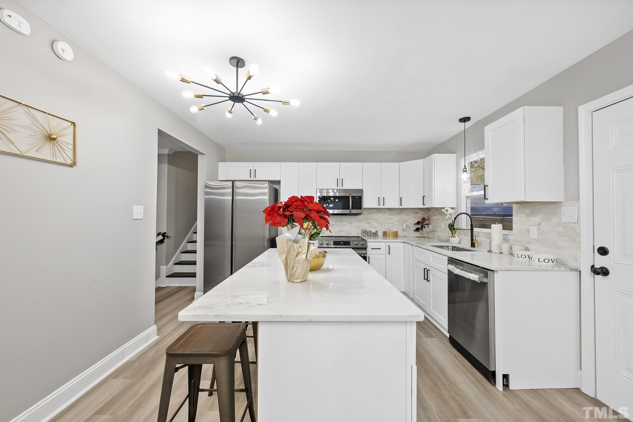 20 Lynn Road Raleigh, NC 27609 - Photo 11 of 29 a kitchen that has a lot of cabinets and wooden floor
