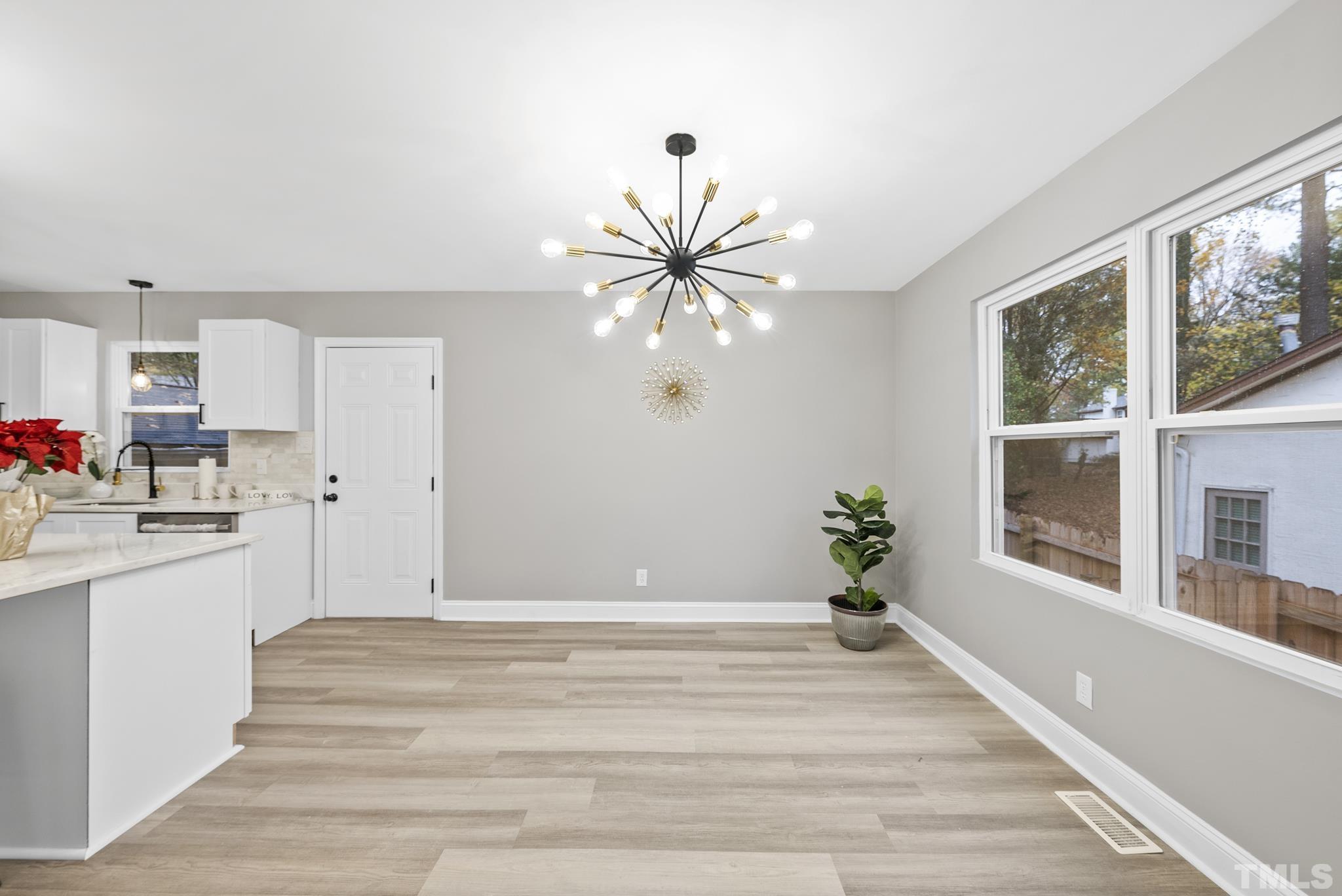 20 Lynn Road Raleigh, NC 27609 - Photo 16 of 29 a view of an empty room with window and cabinet