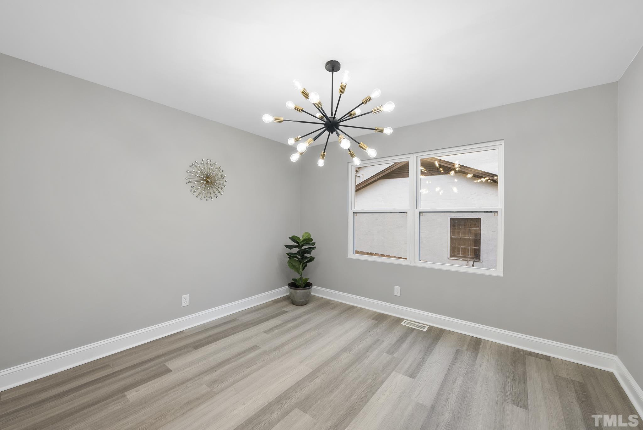 20 Lynn Road Raleigh, NC 27609 - Photo 17 of 29 wooden floor in an empty room with a window