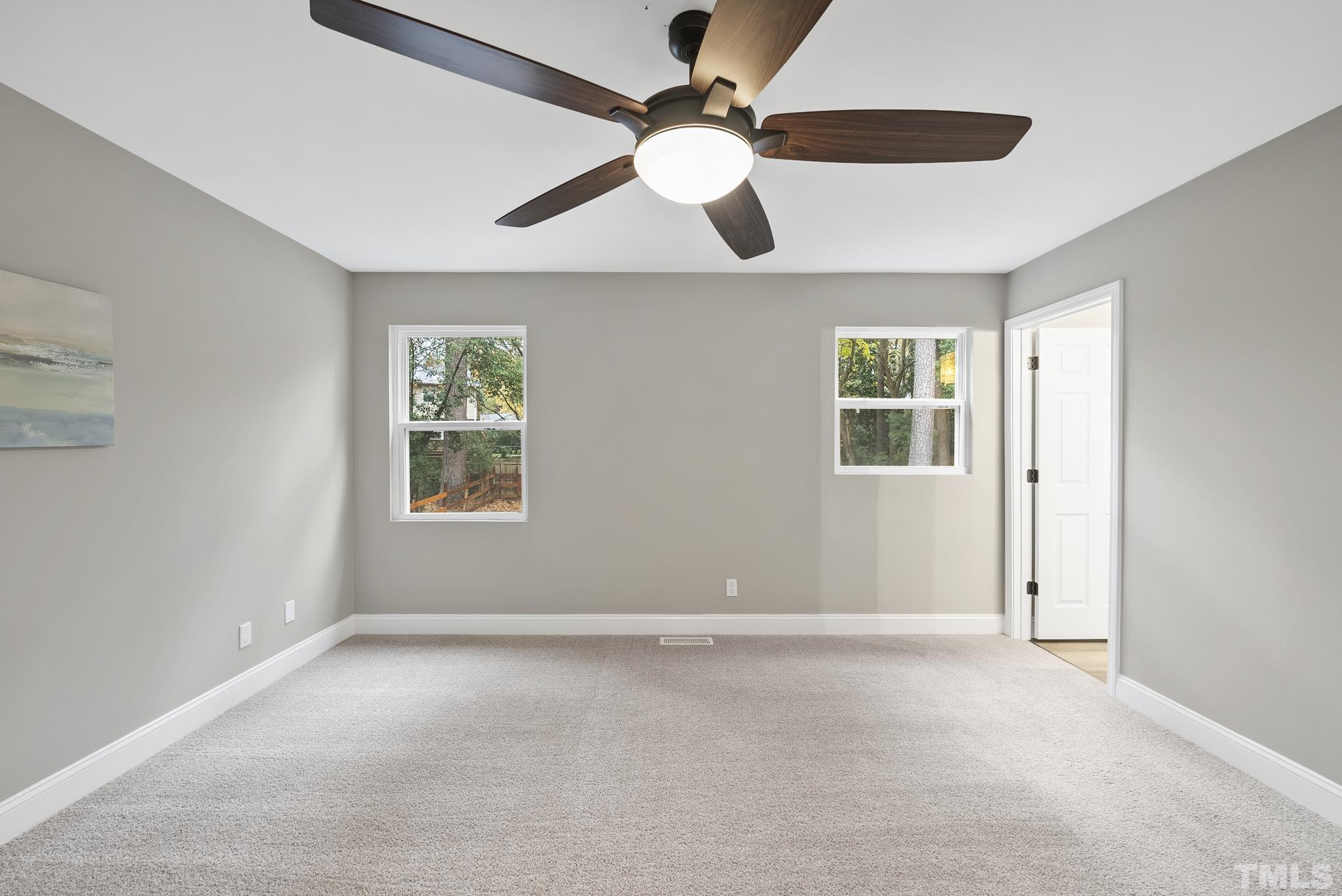 20 Lynn Road Raleigh, NC 27609 - Photo 19 of 29 an empty room with windows and fan