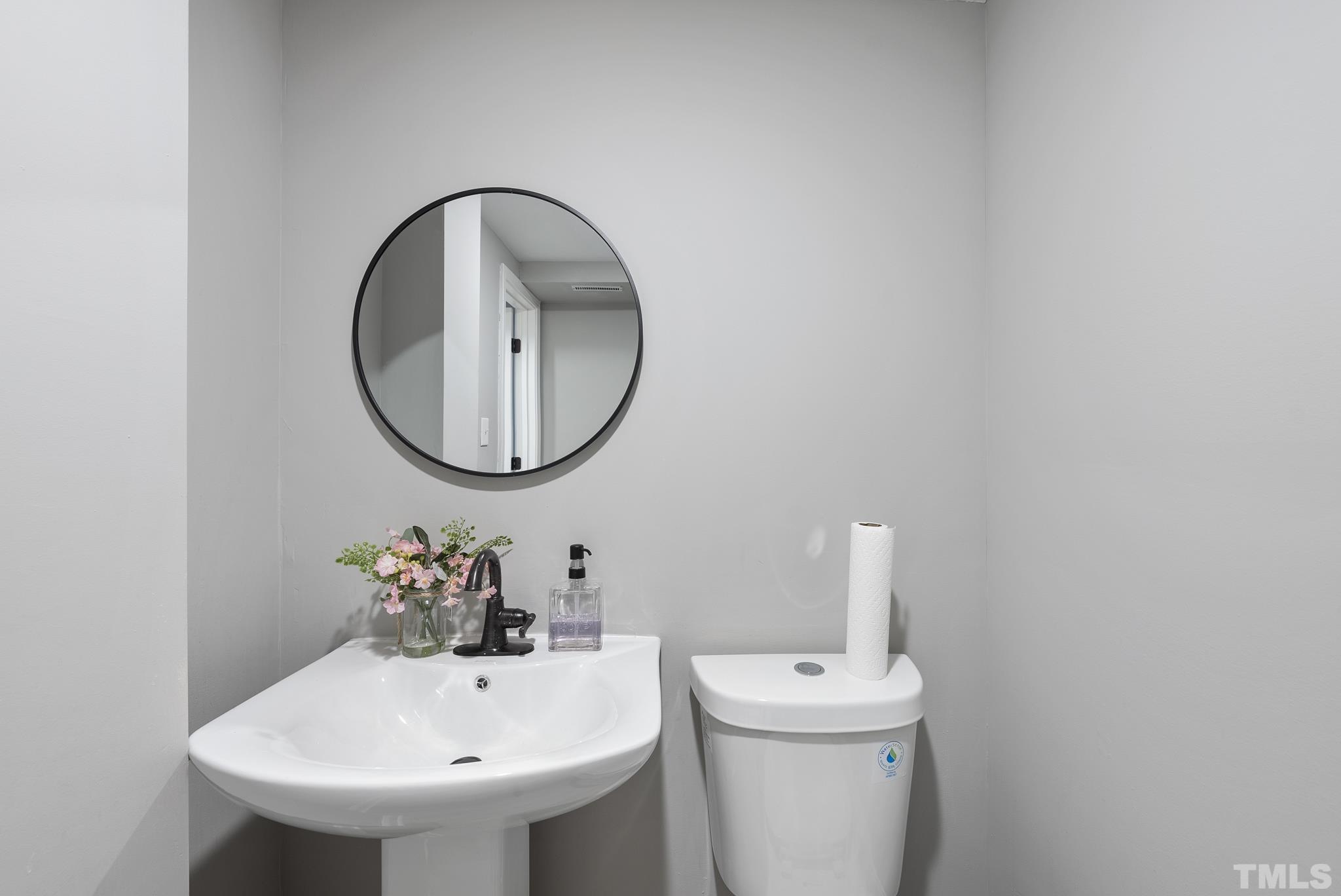 20 Lynn Road Raleigh, NC 27609 - Photo 28 of 29 a bathroom with a sink and a mirror