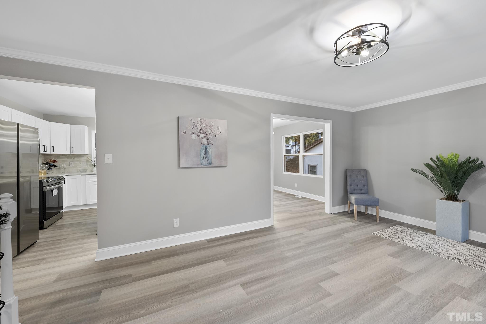 20 Lynn Road Raleigh, NC 27609 - Photo 9 of 29 a view of a livingroom with a chair and a ceiling fan