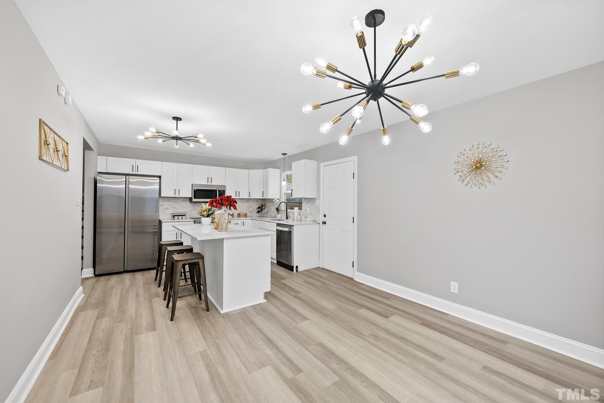 20 Lynn Road Raleigh, NC 27609 - Photo 10 of 29 a kitchen with a refrigerator and a sink