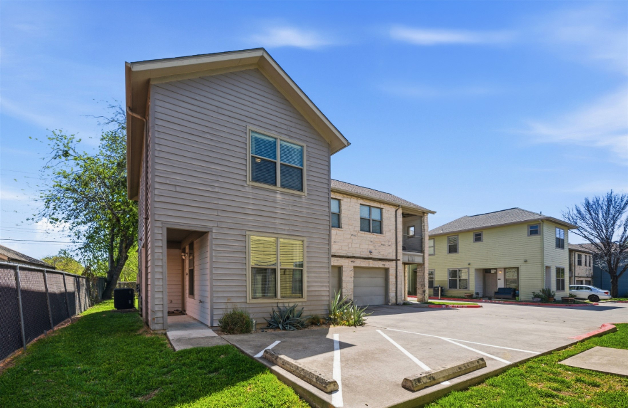 1201 Grove Boulevard, Unit 1304 Austin, TX 78741 - Photo 2 of 19 a front view of a house with a yard