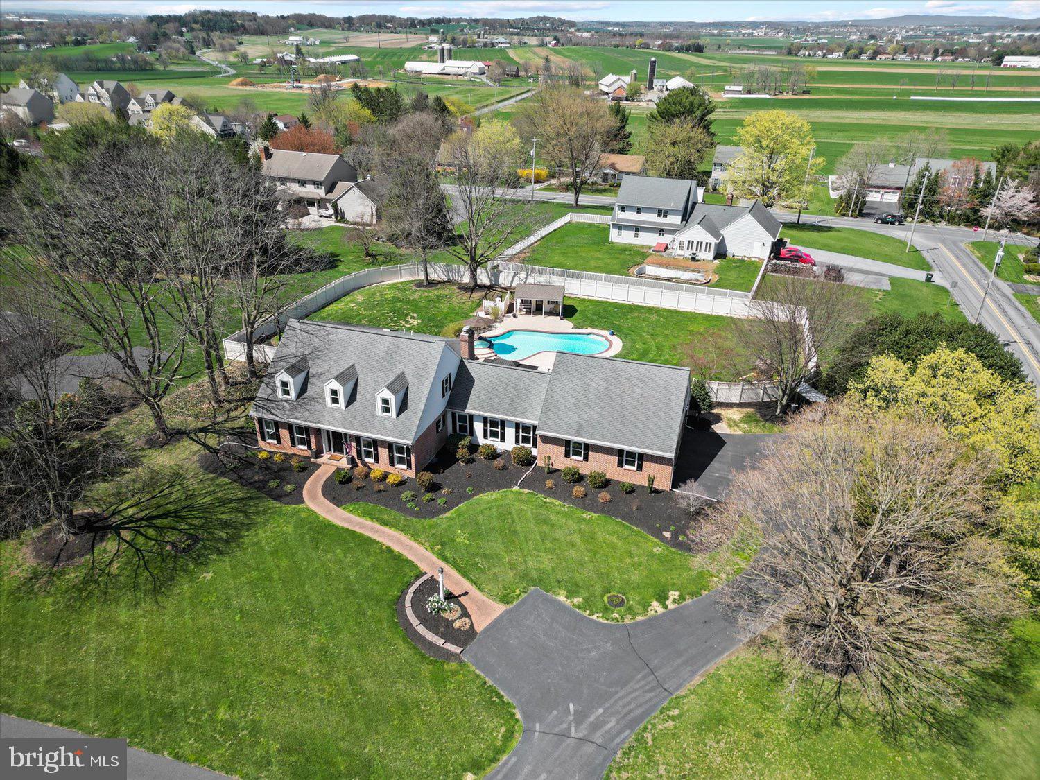an aerial view of a house with outdoor space swimming pool and mountains in the background
