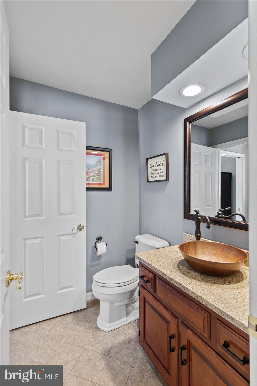 702 Buckwood Lane Lititz, PA 17543 - Photo 26 of 64 a spacious bathroom with a granite countertop toilet a sink and a mirror