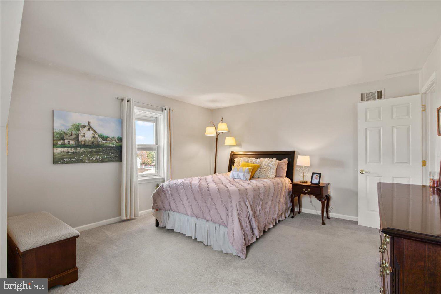 702 Buckwood Lane Lititz, PA 17543 - Photo 39 of 64 a bedroom with a bed lamp and a window