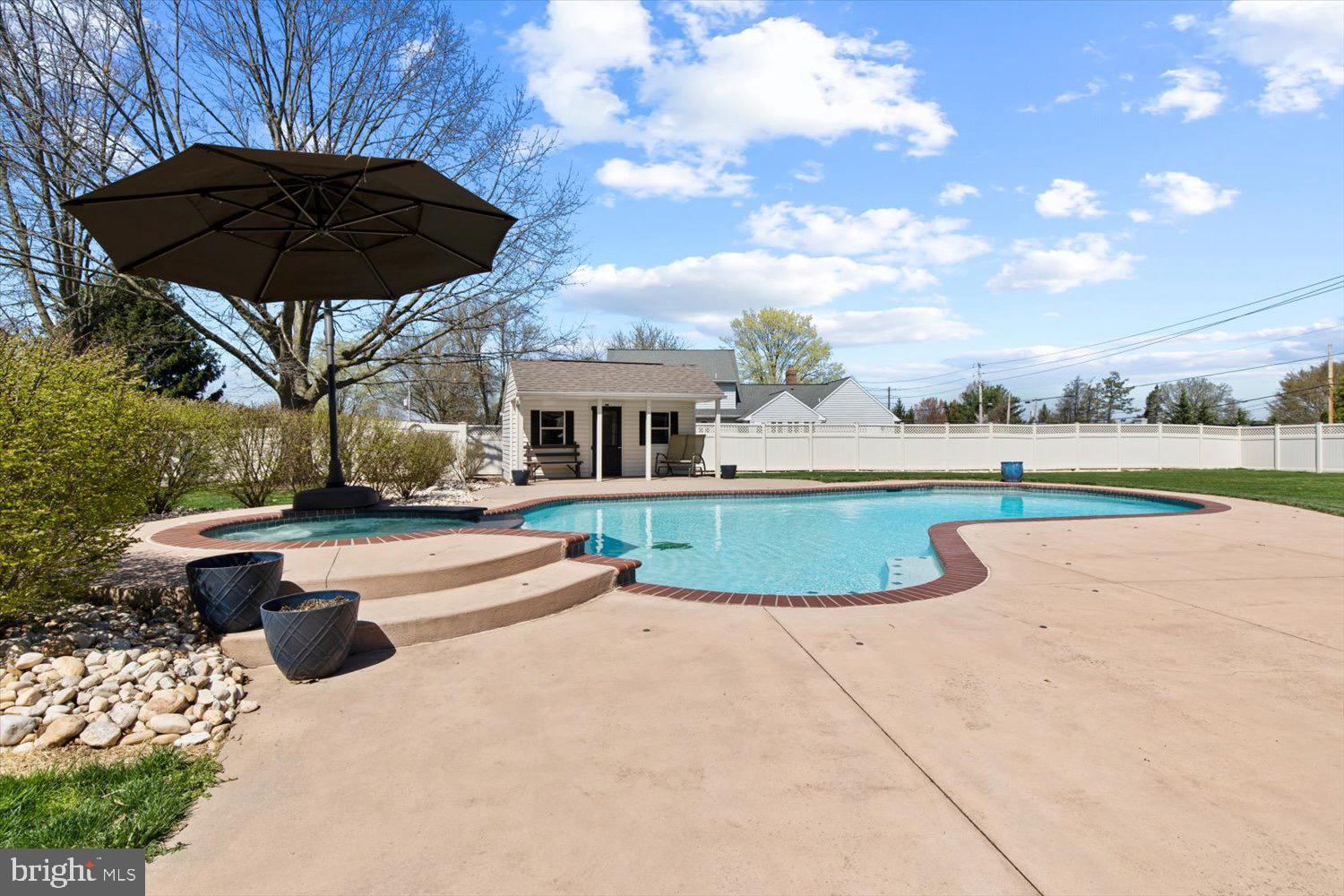 702 Buckwood Lane Lititz, PA 17543 - Photo 54 of 64 a view of a swimming pool with a patio and a yard