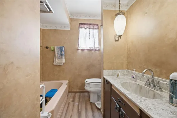 a bathroom with a sink a toilet and mirror