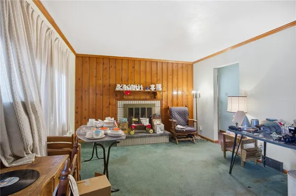 a living room with furniture a fireplace and a large window