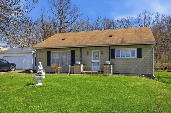 a front view of house with yard outdoor seating and green space