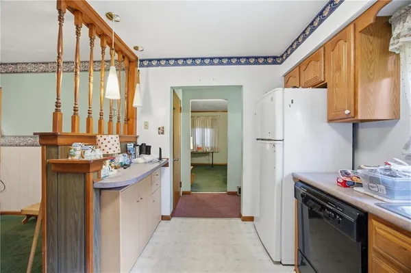 a kitchen with a sink and refrigerator