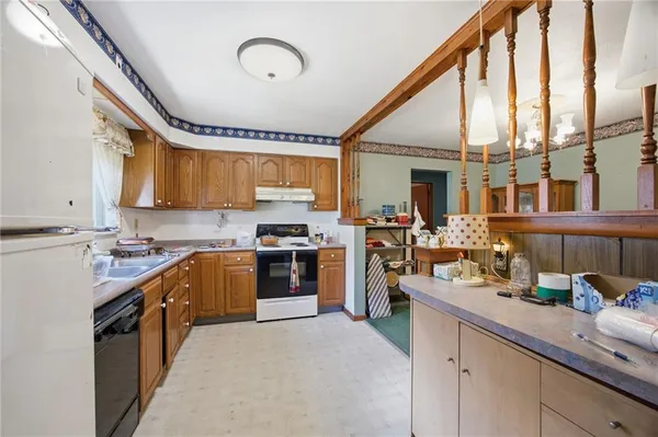 a kitchen with a sink a counter top space stainless steel appliances and cabinets