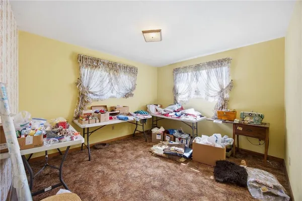 a living room with furniture and a baby crib