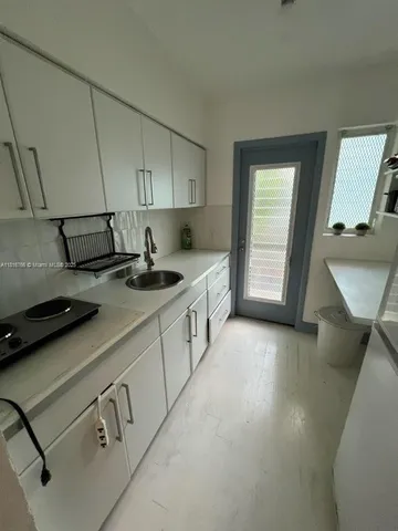 a kitchen that has a sink and a stove