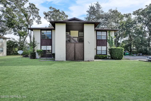 a front view of a house with a garden