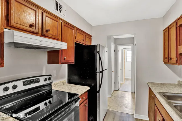 a kitchen with a stove and a refrigerator