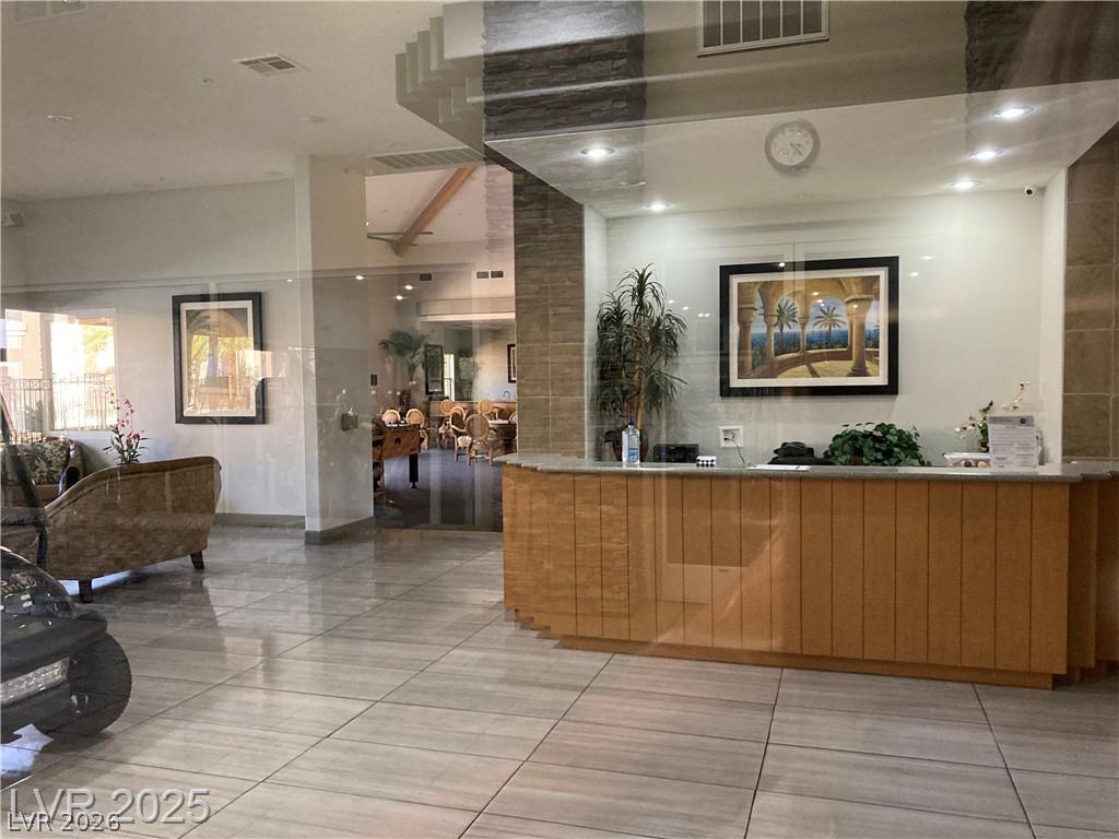 9050 West Warm Springs Road, Unit 1027 Las Vegas, NV 89148 - Photo 35 of 44 A well-appointed lobby welcomes guests with its polished tile flooring and a sleek reception desk.