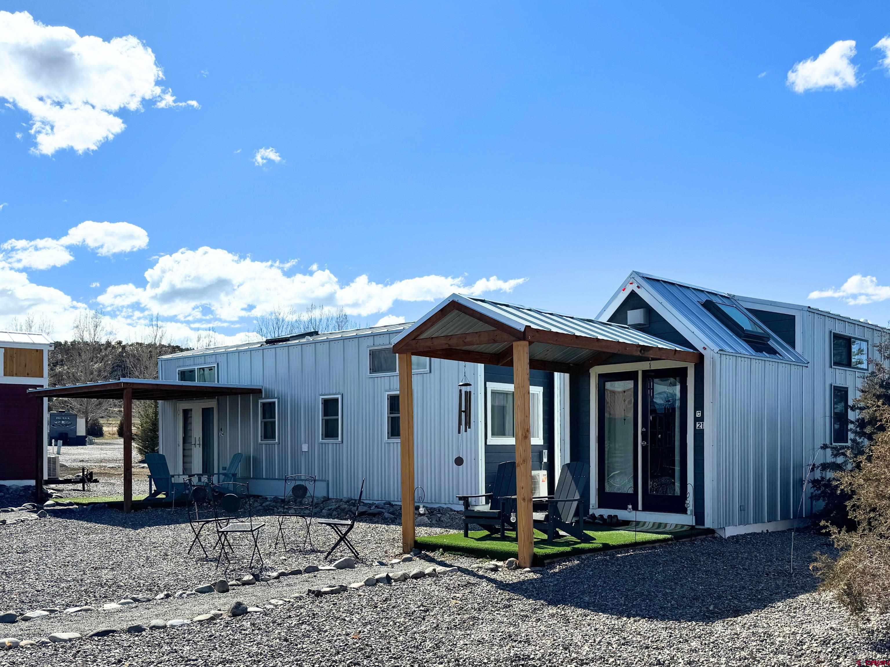 22130 6850 Road, Unit 213 Montrose, CO 81403 - Photo 14 of 26 a front view of a house with garden