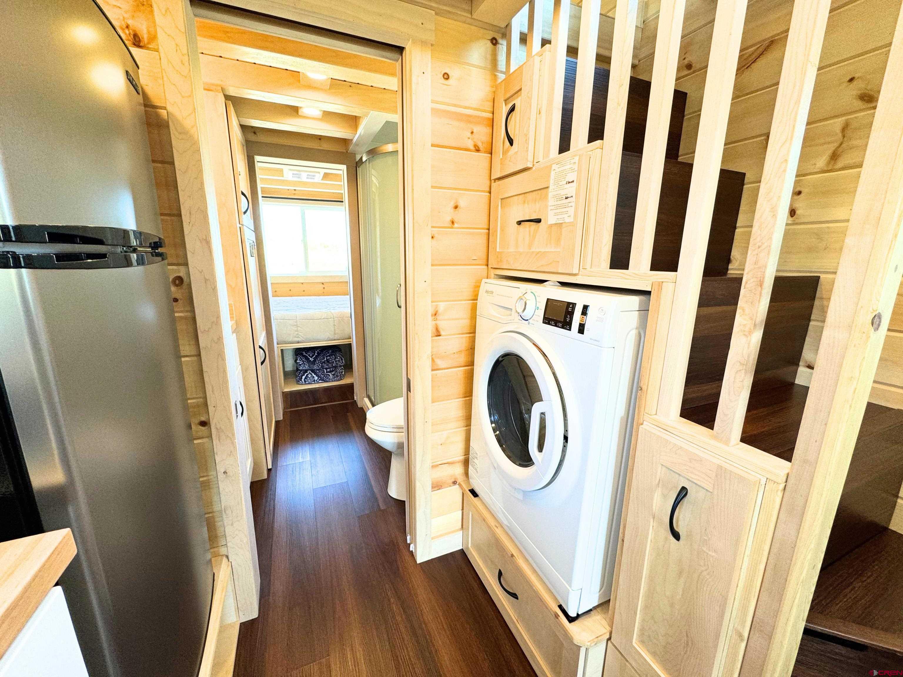 22130 6850 Road, Unit 213 Montrose, CO 81403 - Photo 9 of 26 a view of a hallway with washer and dryer