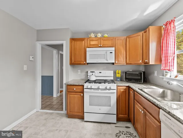 a kitchen with a stove a sink and a microwave