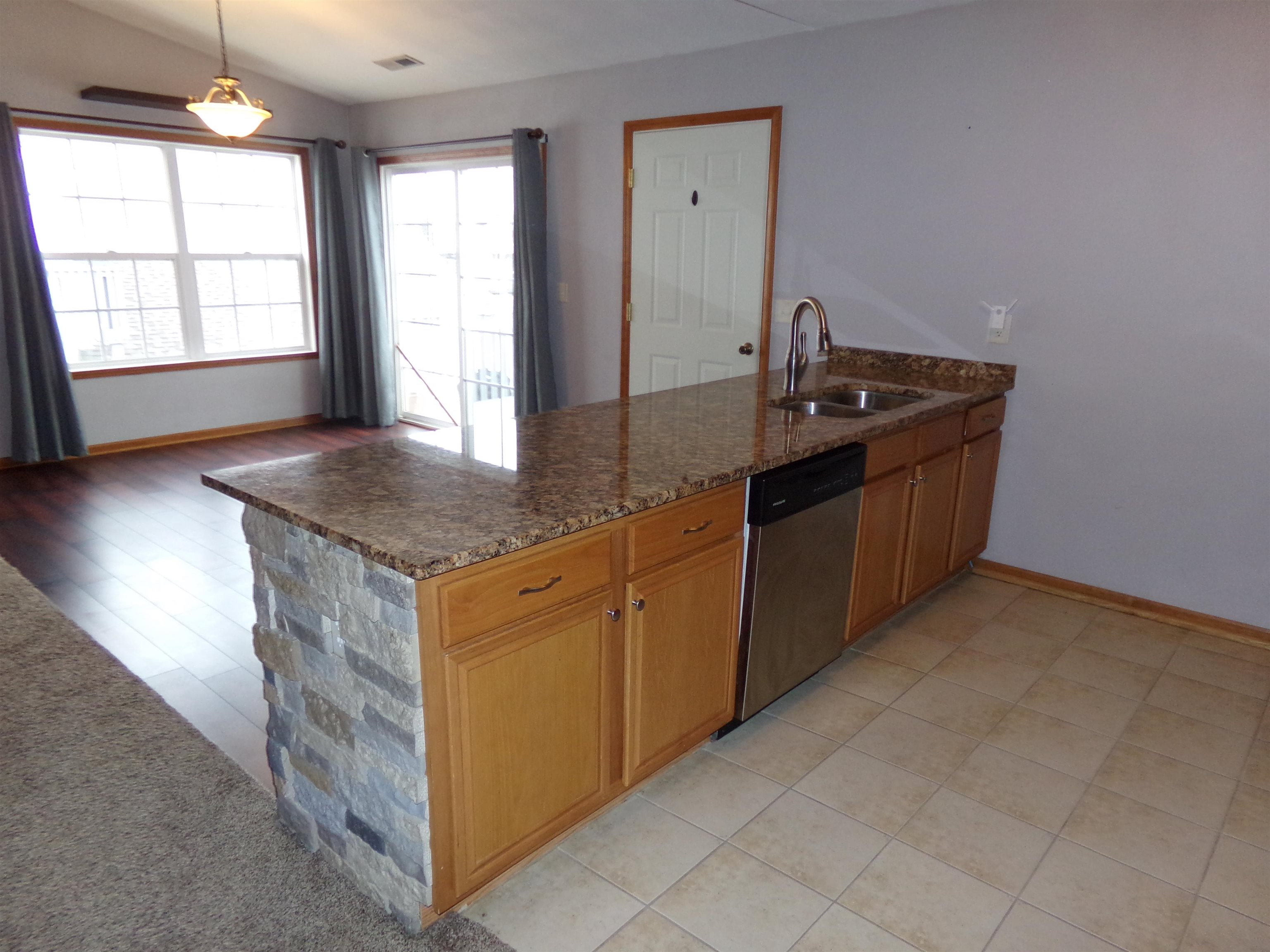 10164 Monarch Road Roscoe, IL 61073 - Photo 4 of 11 a kitchen with granite countertop a sink and a stove