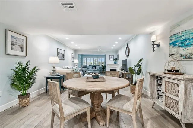 a living room with furniture kitchen view and a flat screen tv