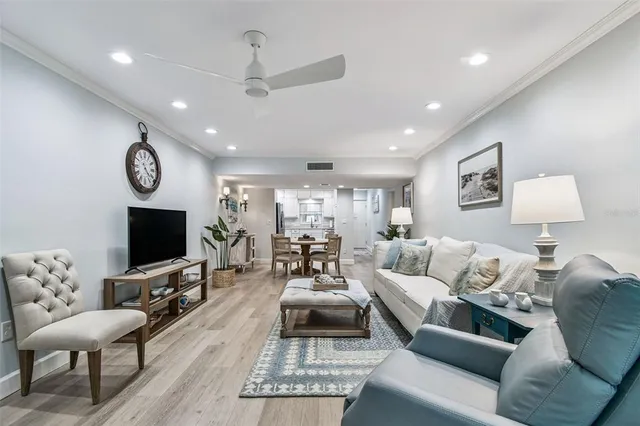 a living room with furniture potted plant and wooden floor