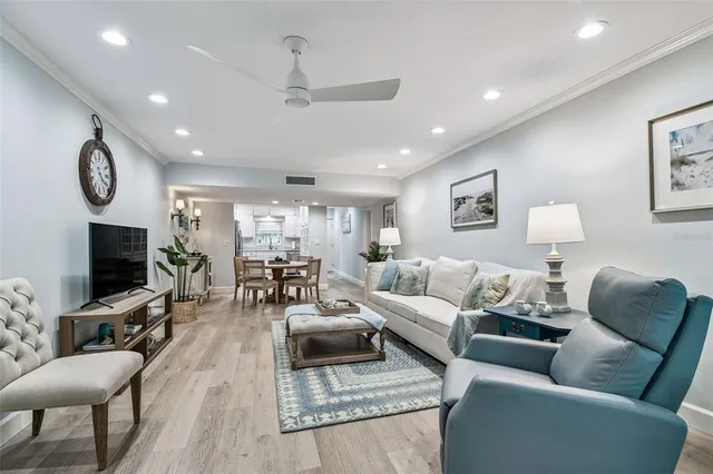 a living room with furniture and a potted plant