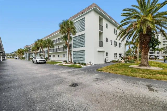 a dining room with furniture and a potted plant