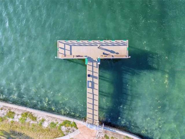 a dining room with furniture and a potted plant