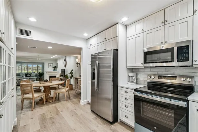 a kitchen with granite countertop a sink and a stove