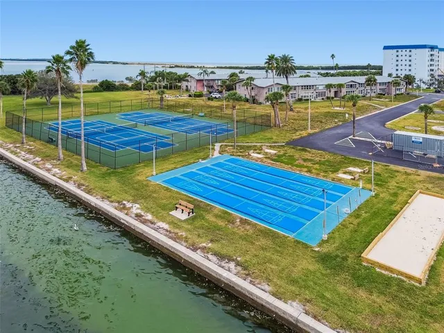a room with pool table and windows