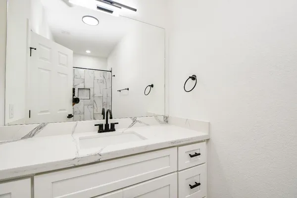 a bathroom with a sink and a mirror