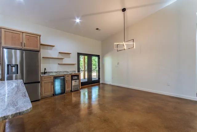 a kitchen with stainless steel appliances granite countertop a stove refrigerator sink and microwave