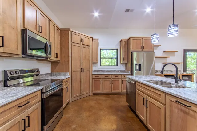 a kitchen with refrigerator and window