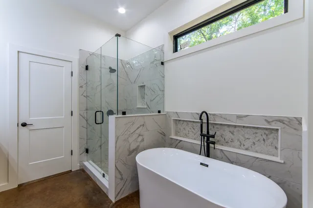 a spacious bathroom with a granite countertop sink and a mirror